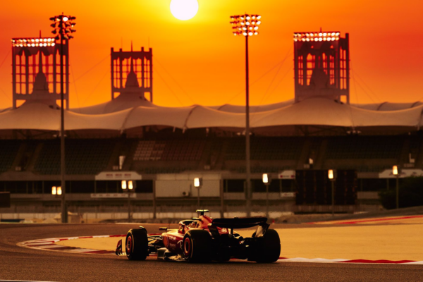 A Ferrari being driven at Bahrain in the sunset