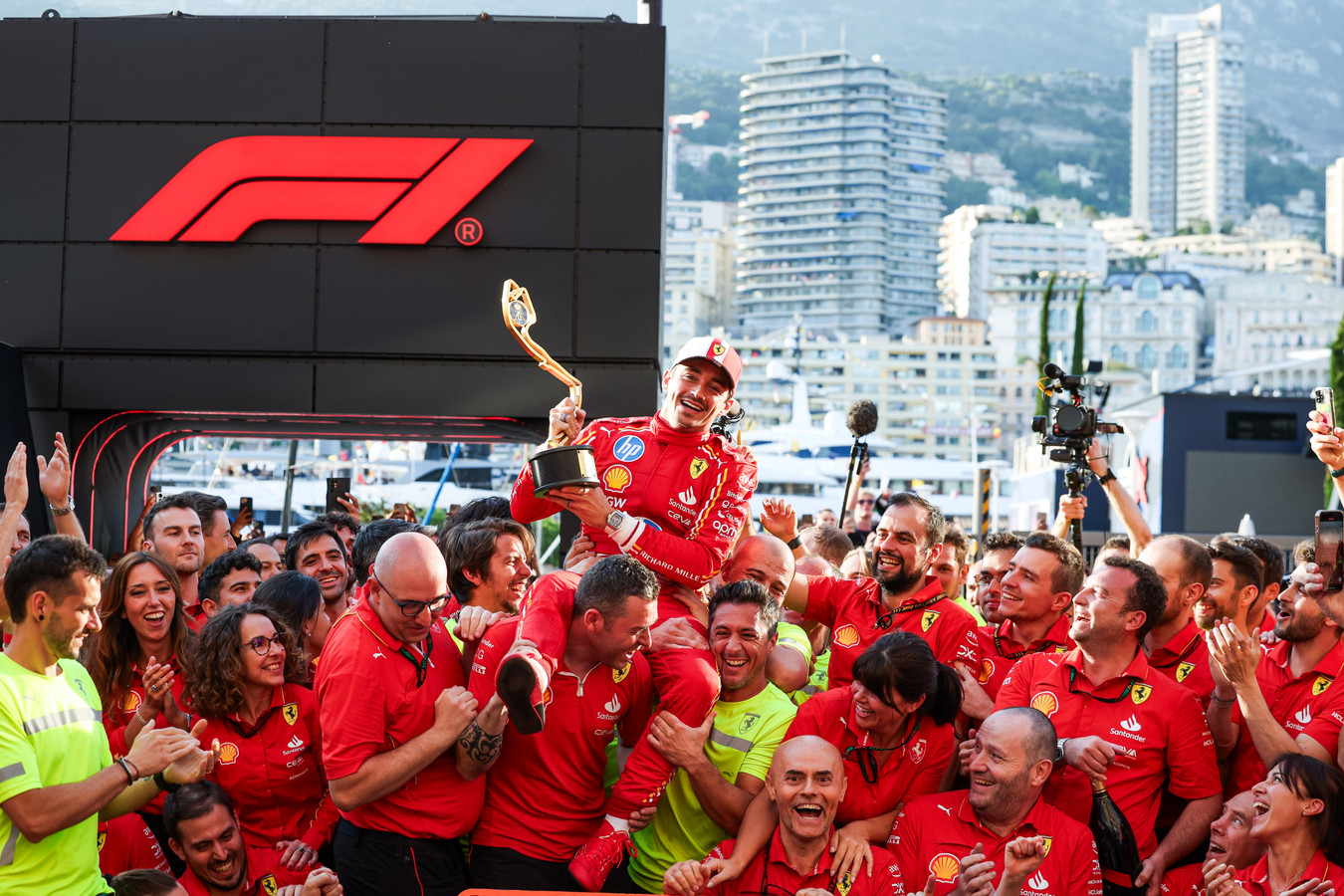 Charles Leclerc celebrating with the team after his maiden Monaco GP victory during the F1 2024 season