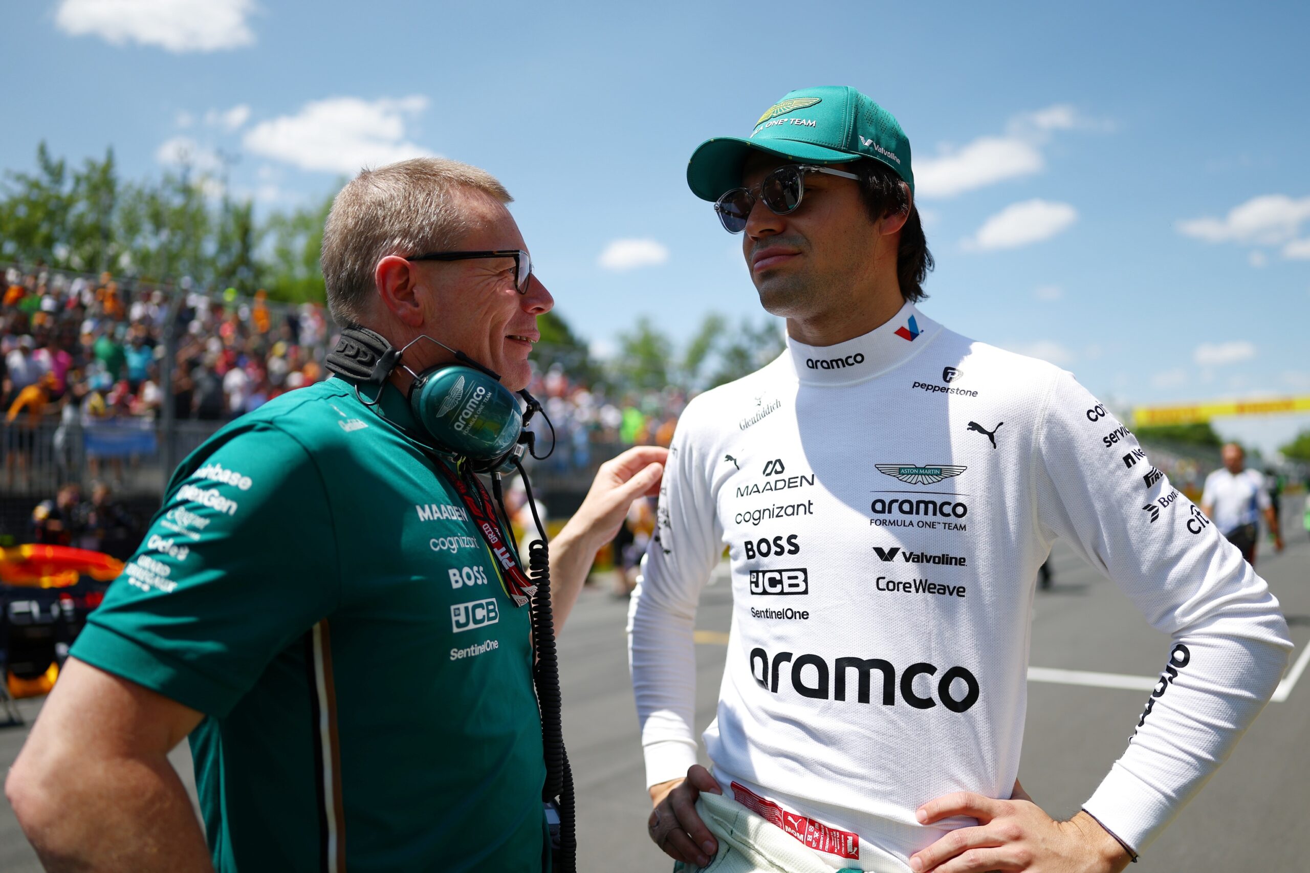 Aston Martin driver Lance Stroll speaking with Andy Cowell