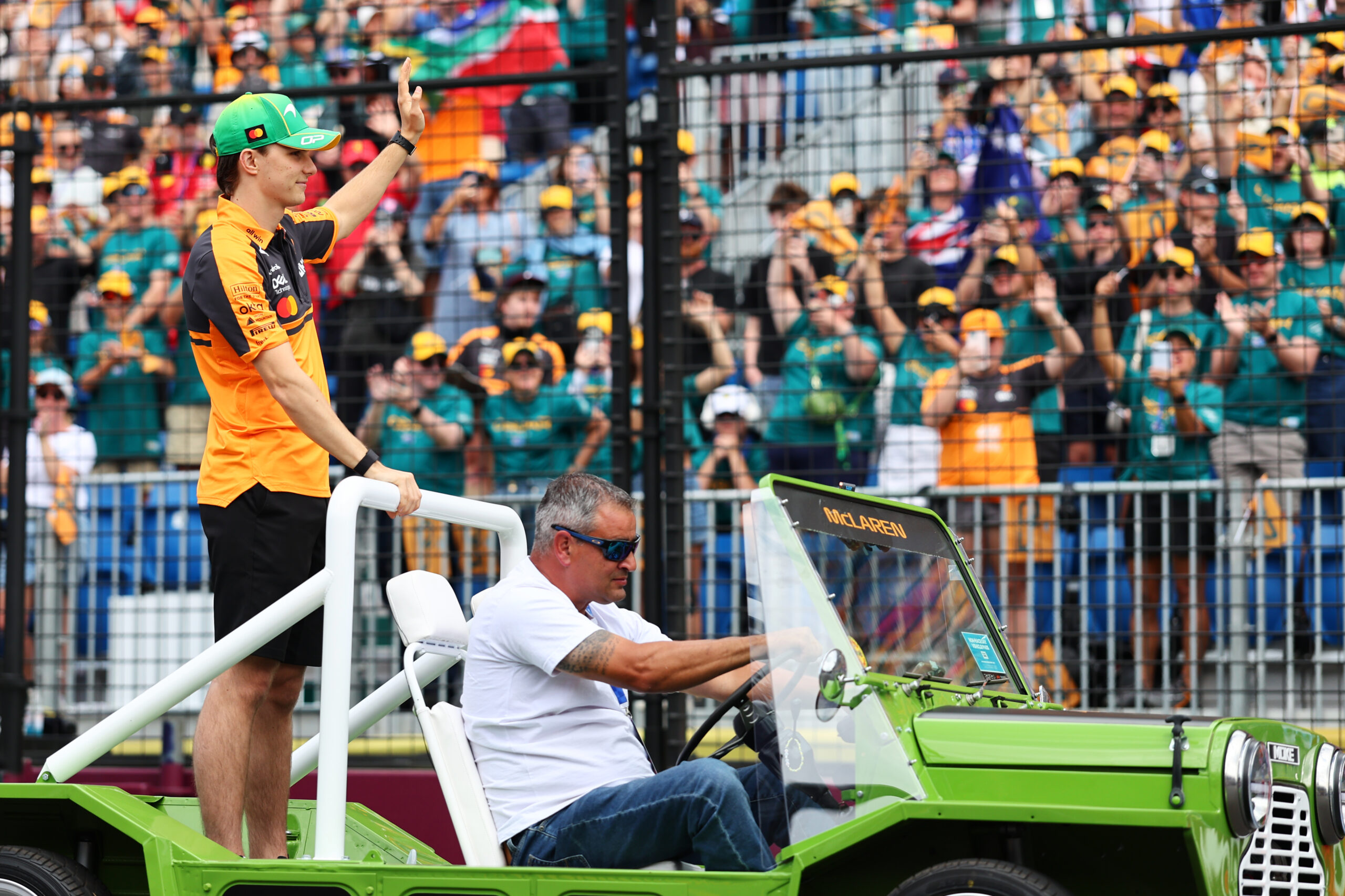 Oscar Piastri climbs into his McLaren F1 car during the 2026 Australian Grand Prix at Albert Park in Melbourne.