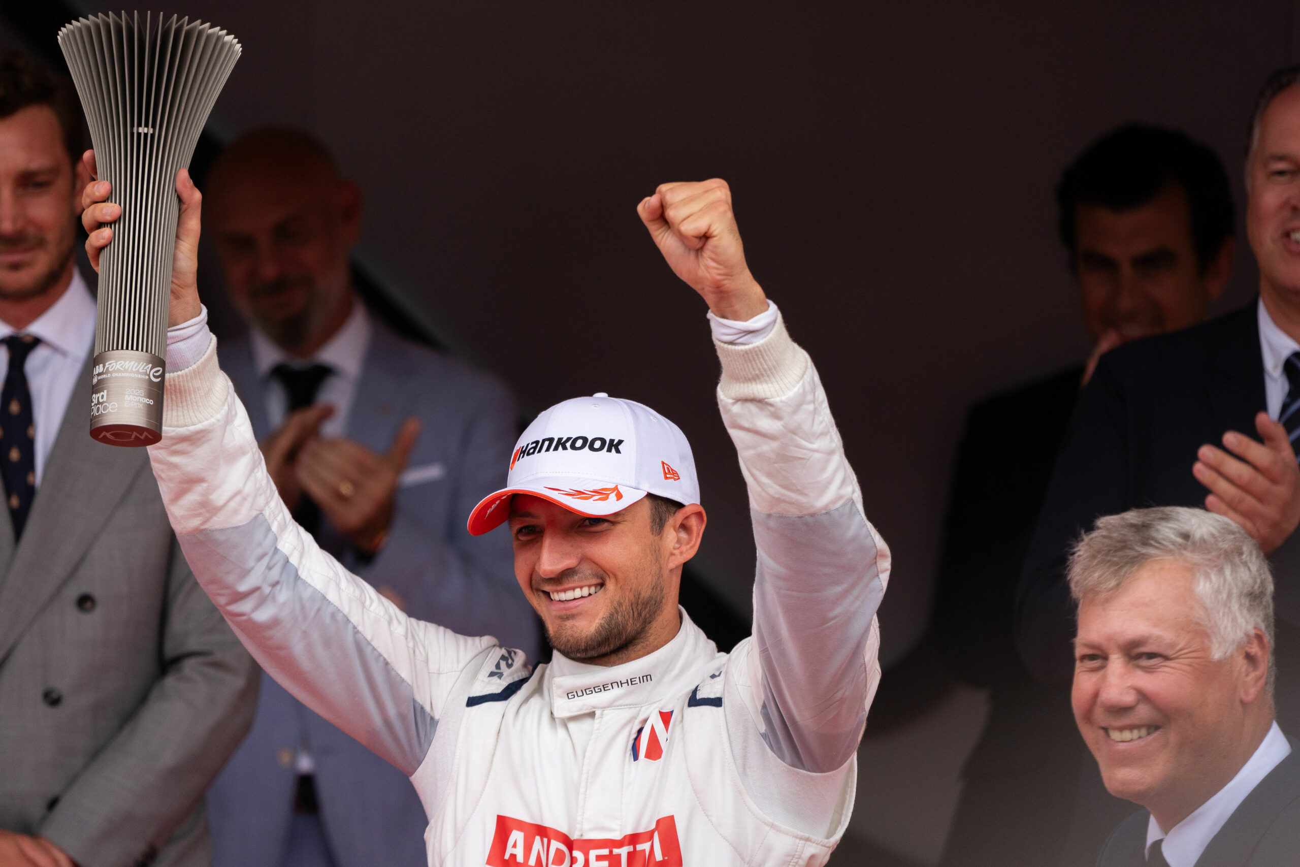 Andretti Formula E driver, Jake Dennis, standing on the podium during the FE Monaco E-Prix 2025.