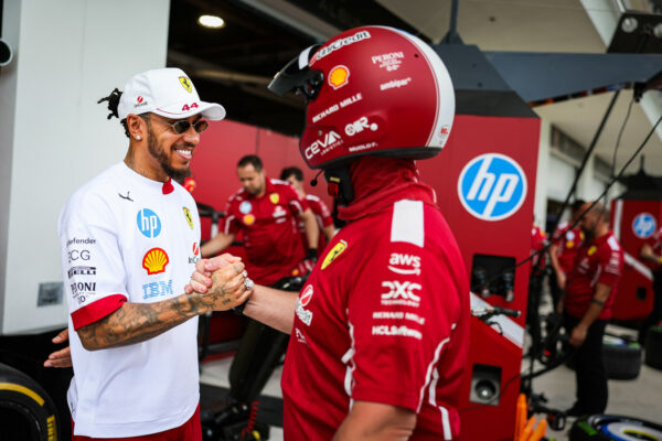 Hamilton with Ferrari crew member in Miami on Thursday