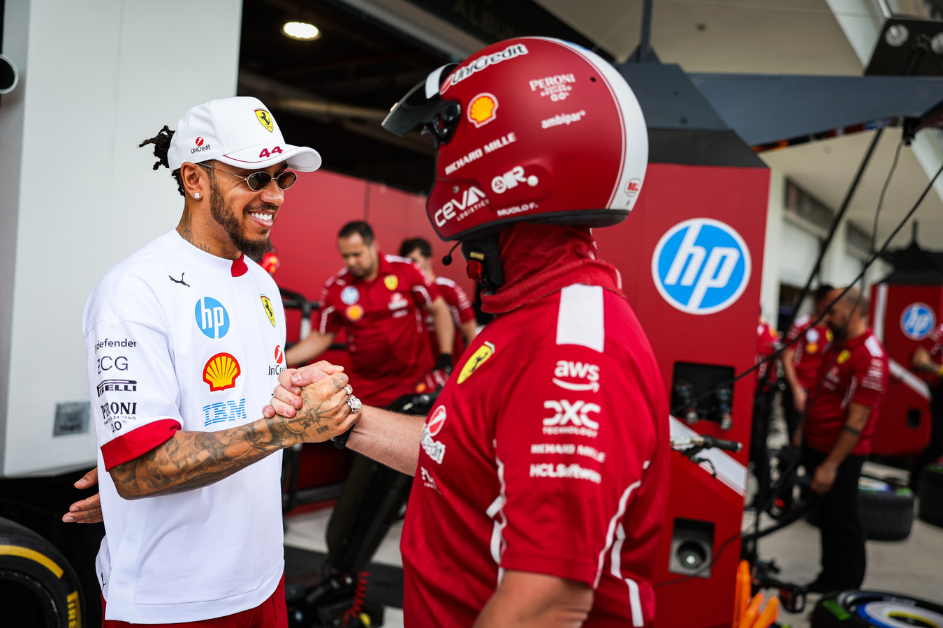 Hamilton with Ferrari crew member in Miami on Thursday