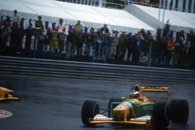 Michael Schumacher driving a Benetton-Ford in the wet on his way to a first Formula 1 victory at the 1992 F1 Belgian Grand Prix.