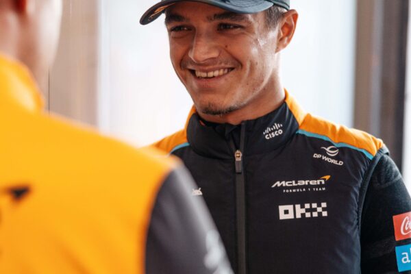Norris: MCL39 feels “similar” to 2024 F1 car which is a “good start” Lando Norris in a McLaren suit, looking over a McLaren employee