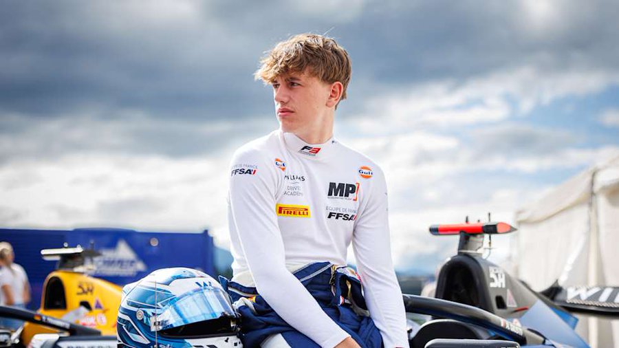 Alessandro Giusti wearing his MP Motorsport car and showcasing his helmet design with blue, orange, and white colours at Monza