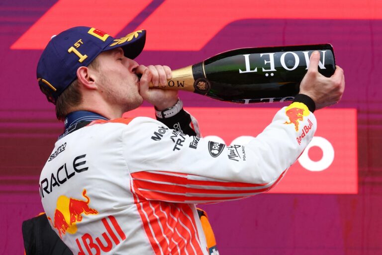 Race winner Max Verstappen of the Netherlands and Oracle Red Bull Racing drinks Champagne on the podium during the F1 Japanese GP