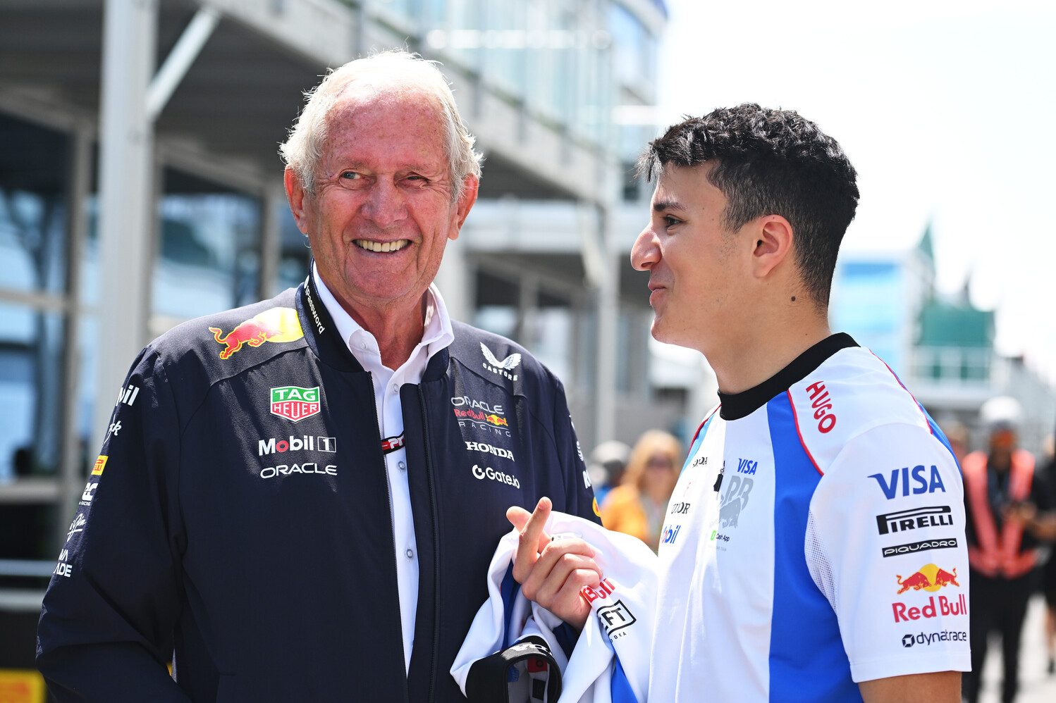 Racing Bulls driver Isack Hadjar speaks with Red Bull advisor Helmut Marko in the paddock during the F1 Canadian GP weekend