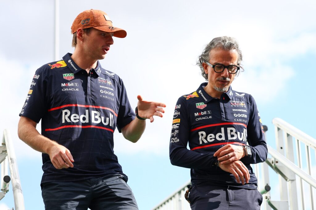 Verstappen (left) and Mekies (right) talking in the paddock