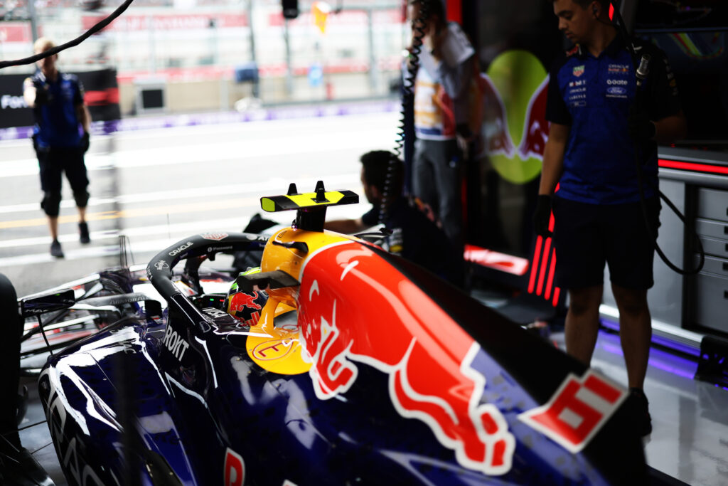 Isack Hadjar in the Red Bull pits at Circuit de Spa-Francorchamps. Grid penalties for unapproved power unit changes mean Hadjar will start from the back at the 2026 F1 Belgian GP.