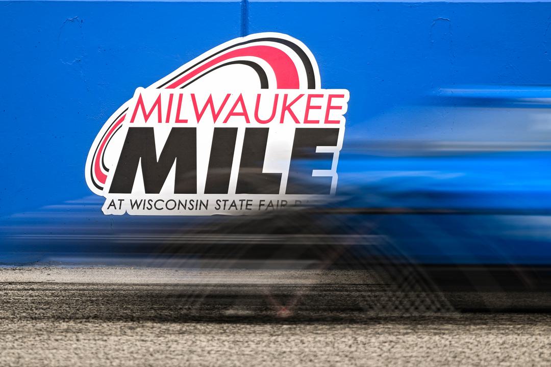 INDYCAR postpones Milwaukee Race 1 to Sunday after rain halts the race with O’Ward leading Rosenqvist and Rossi.