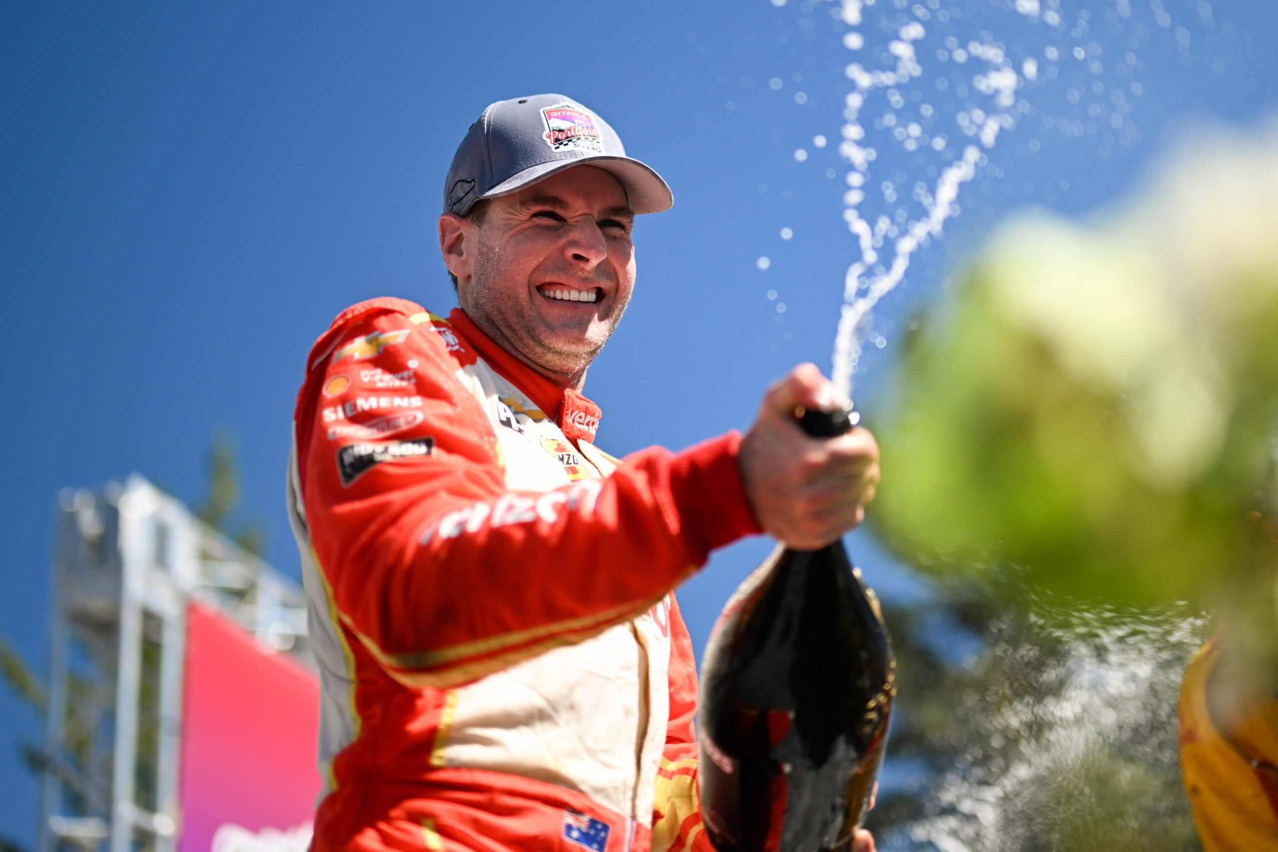 Will Power sprays champagne after winning the Indycar Grand Prix of Portland