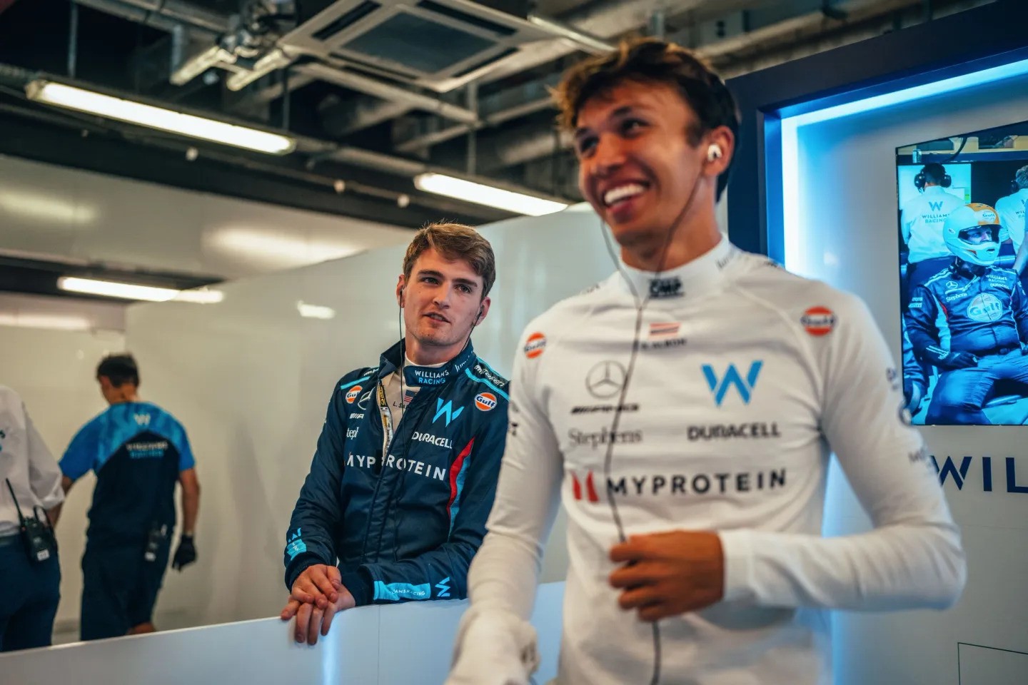 Alex Albon and teammate Logan Sargeant in the Williams garage during the 2023 Abu Dhabi Grand Prix weekend