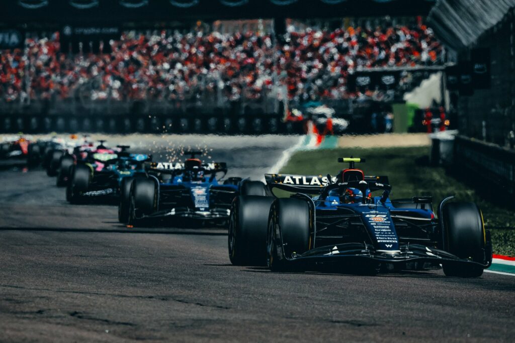 Carlos Sainz of Williams Racing leading a train of cars at the F1 Imola GP