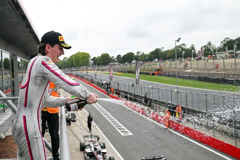 Lucas Fluxá takes his first 2026 GB3 win at Brands Hatch as Bedrin’s false-start penalty sends a four-way title fight to Barcelona.