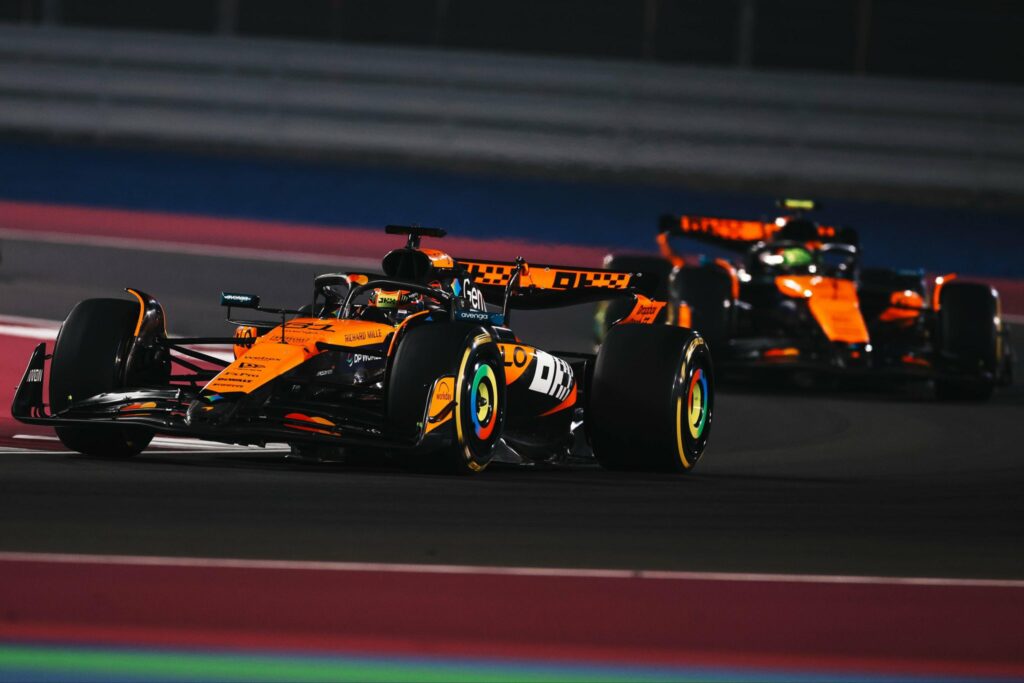 McLaren's Oscar Piastri and Lando Norris on track during the 2025 F1 Qatar GP.