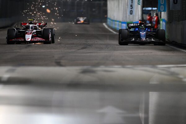 Oliver Bearman driving his Haas VF-25 through the streets of Marina Bay during the F1 Singapore GP 2025 under the night lights