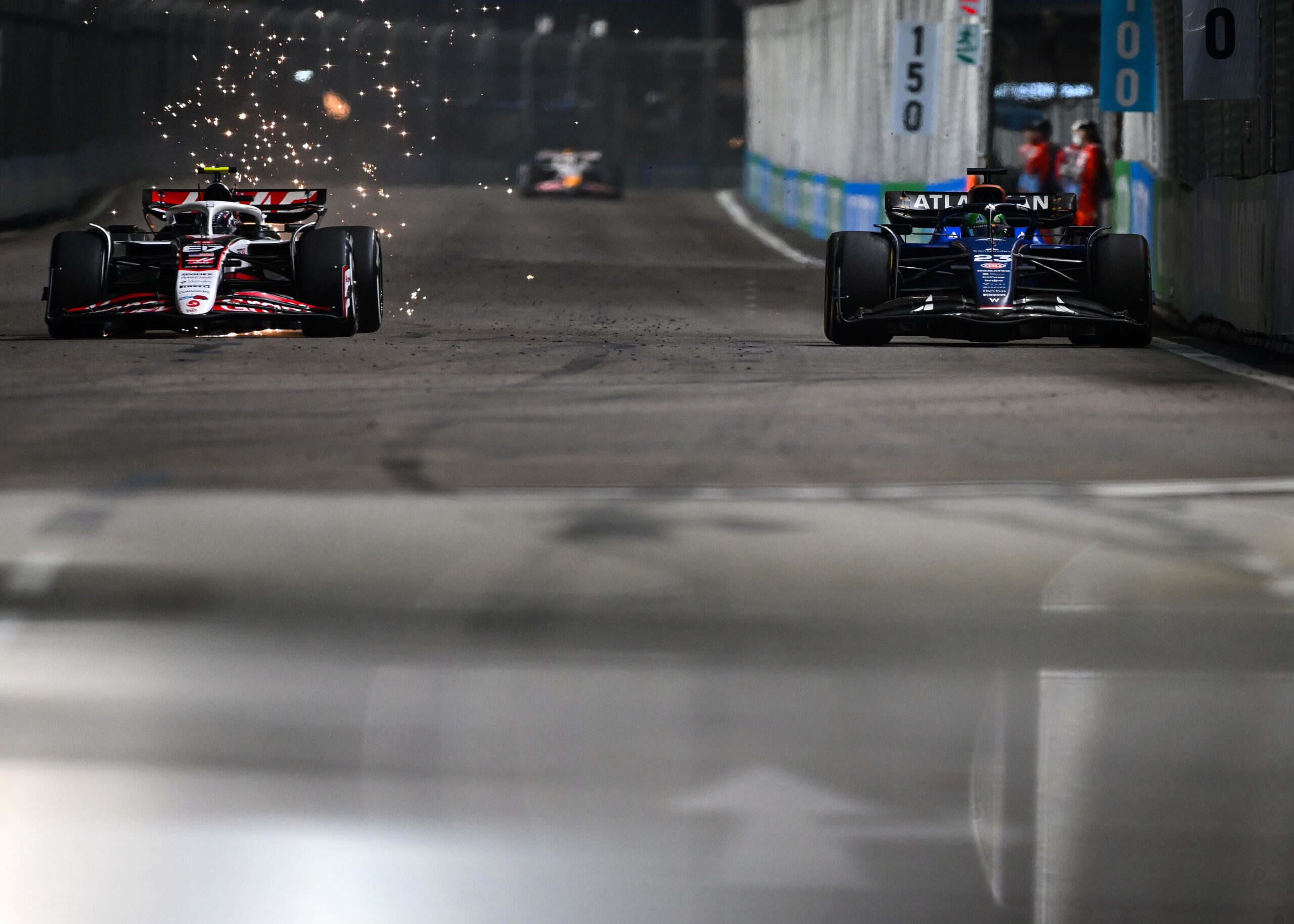 Oliver Bearman driving his Haas VF-25 through the streets of Marina Bay during the F1 Singapore GP 2025 under the night lights